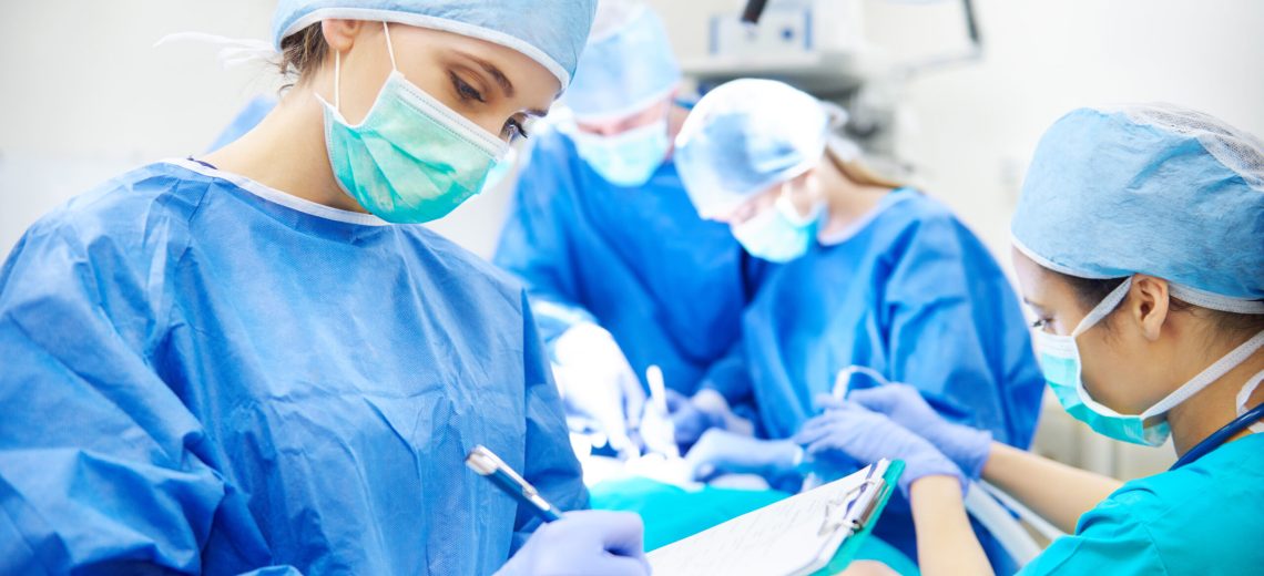 Surgeon writing down some operation notes