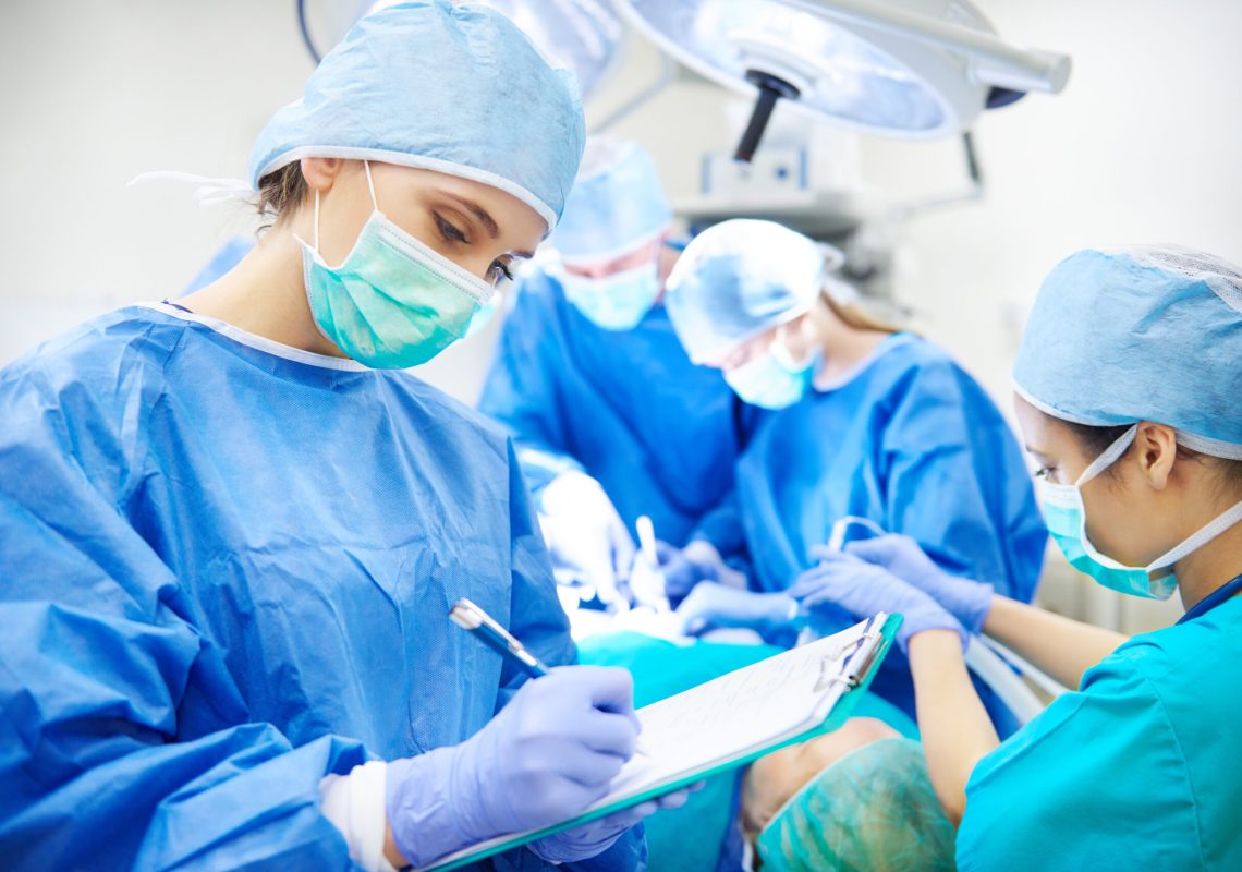 Surgeon writing down some operation notes